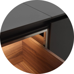 Close-up of modern kitchen drawer with dark exterior and wooden interior