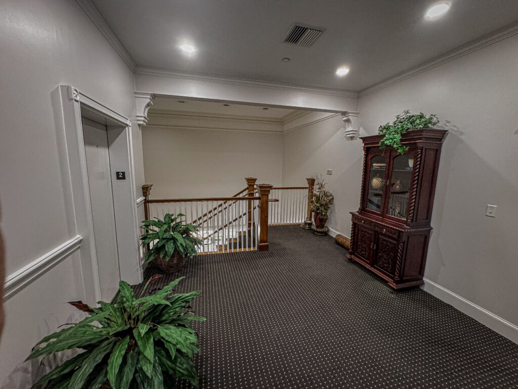 Casabianca Remodeling completed Texas home remodeling services with a fully renovated hallway featuring new lighting, paint, and decor